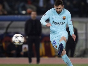 Barcelona's Lionel Messi takes a free kick during the Champions League quarterfinal second leg soccer match between between Roma and FC Barcelona, at Rome's Olympic Stadium, Tuesday, April 10, 2018.