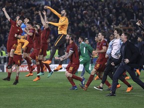 Roma players celebrate reaching the semifinals after the Champions League quarterfinal second leg soccer match between between Roma and FC Barcelona, at Rome's Olympic Stadium, Tuesday, April 10, 2018.
