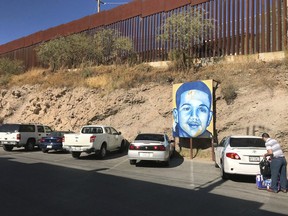 FILE - In this Dec. 4, 2017, file photo, a portrait of 16-year-old Mexican youth Jose Antonio Elena Rodriguez, who was shot and killed in Nogales, Sonora, Mexico, is displayed on the Nogales street where he was killed that runs parallel with the U.S. border. Closing arguments are expected in Tucson, Ariz., this week in the trial of U.S. Border Patrol agent Lonnie Swartz, charged in the 2012 fatal shooting 16-year-old Jose Antonio Elena Rodriguez across the Mexican border.