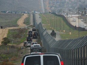 FILE - In this March 13, 2018, file photo, a motorcade carrying President Donald Trump drives along the border in San Diego. California has rejected the federal government's initial plans for National Guard troops to the border because the work is considered too closely tied to immigration enforcement.