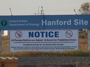 FILE - In this May 9, 2017, file photo, signs are posted near the entrance to the Hanford Nuclear Reservation in Richland, Wash. Federal investigators say problems first identified six years ago continue to plague the multi-billion-dollar Hanford vitrification plant that would be used to treat some of the nation's deadliest nuclear waste.