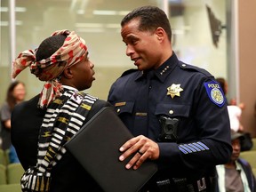 FILE--In this April 10, 2018, file photo, Stevante Clark, the brother of Stephon Clark, who was shot and killed by Sacramento police, talks with Sacramento Police Chief Daniel Hahn before a meeting of the Sacramento City Council in Sacramento, Calif. Clark was arrested on Thursday, April 19, 2018, and accused of making threats to commit a crime resulting in death or great bodily injury and telephoning 911 with the intent to annoy or harass.