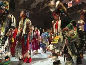 FILE--In this April 28, 2017 file photo, dancers take part in the grand entry to the Gathering of Nations in Albuquerque, N.M. The Gathering of Nations, one of the world's largest gatherings of indigenous people, is set to begin Friday, April 27, 2018 in Albuquerque, drawing around 3,000 dancers from hundreds of tribes in the U.S., Canada and Mexico and generally pulling in about 80,000 visitors with dances, drum contests and various competitions.