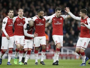 Arsenal's Alexandre Lacazette, 3rd left, celebrates with teammates after scoring his sides fourth goal during the Europa League quarterfinal, first leg soccer match between Arsenal and CSKA Moscow at the Emirates stadium in London Thursday, April 5, 2018.