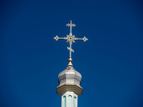 A cross glistens in the sunlight at a church in Etobicoke, Ont.