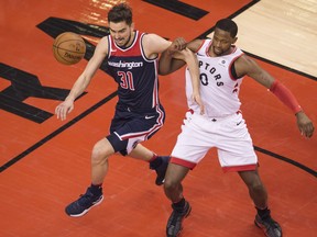 Washington Wizards guard Tomas Satoransky (left) chases a loose ball against Toronto Raptors forward C.J. Miles on April 17.