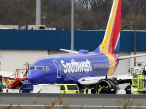 A Southwest Airlines jet sits on the runway at Philadelphia International Airport after it was forced to land with an engine failure on April 17, 2018.