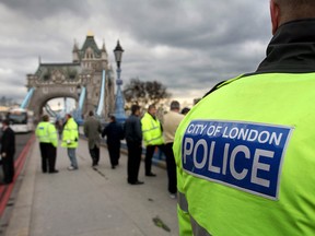 City of London police officers and officers from the driver vehicle licensing agency monitor traffic on Tower Bridge in the City of London, U.K., Thursday, March 9, 2006.