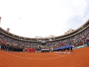 Spain and Germany players line up before the start of the first World Group Quarter final Davis Cup tennis match between Spain and Germany at the bullring in Valencia, Spain, Friday April 6, 2018.
