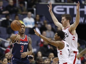 Toronto Raptors guard Kyle Lowry and centre Jakob Poeltl defend Washington Wizards guard Bradley Beal on Feb. 1.