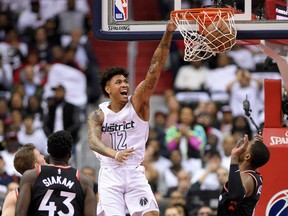 Wizards forward Kelly Oubre Jr. dunks against the Toronto Raptors' Pascal Siakam and CJ Miles during the first half of Game 3 of their NBA first-round playoff series on Friday night in Washington.
