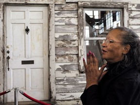 Rhea McCauley, a niece of Rosa Parks, reacts to a musical performance, Sunday, April 1, 2018, in front of the rebuilt house of Parks, at the WaterFire Arts Center, in Providence, R.I. Rosa Parks moved to the house in Detroit in 1957, two years after refusing to give up her bus seat. The house is making a brief showing on Easter weekend.