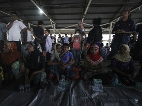 Ethnic-Rohingya women rest at a temporary shelter in Bireuen, Aceh province, Indonesia, Friday, April 20, 2018. Indonesian fishermen rescued dozens of Rohingya Muslims from a boat stranded off Aceh province on Friday, police said, in the latest attempt by members of the persecuted ethnic group to flee Myanmar by sea.