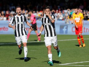 Juventus's Paulo Dybala, right, flanked by his teammate Miralem Pianic, celebrates after scoring during an Italian Serie A soccer match between Benevento and Juventus, at the Ciro Vigorito Stadium, in Benevento, Italy, Saturday, April 7, 2018. (Mario Taddeo/ANSA via AP) ITALY OUT