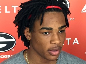 Georgia's Nicolas Claxton, wearing an earring, speaks with reporters during an  NCAA college basketball media availability, Tuesday, April 10, 2018, in Athens. Ga. Georgia's players says they're embracing new coach Tom Crean and his new rules. Claxton said earrings wouldn't have been allowed under former coach Mark Fox, who was fired.