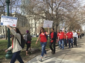 Colorado teachers rally outside the state Capitol to demand more funding for schools and oppose changes to the state's pension system in Denver, Monday, April 16, 2018. They later headed inside to lobby lawmakers in an event organized by the Colorado Education Association, the state's biggest teachers union.