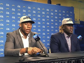 Los Angeles Chargers draft picks linebacker Uchenna Nwosu, left, and defensive tackle Justin Jones speak to reporters at the NFL football team's training complex in Costa Mesa, Calif., Saturday, April 28, 2018. Nwosu was the Chargers' second-round pick in the draft, and Jones was a third-round selection.