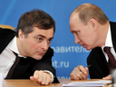 Kremlin advisor Vladislav Surkov speaks to Russian Prime Minister Vladimir Putin, in 2012.