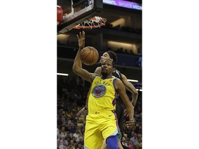 Golden State Warriors forward Kevin Durant, foreground, dunks against Sacramento Kings center Willie Cauley-Stein during the first quarter of an NBA basketball game Saturday, March 31, 2018, in Sacramento, Calif.