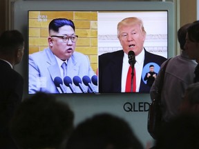 People watch a TV screen showing file footage of U.S. President Donald Trump, right, and North Korean leader Kim Jong Un during a news program at the Seoul Railway Station in Seoul, South Korea, Saturday, April 21, 2018. North Korea said Saturday it has suspended nuclear and long-range missile tests and plans to close its nuclear test site ahead of a new round of negotiations with South Korea and the United States. There was no clear indication in the North's announcement if it would be willing to deal away its arsenal.