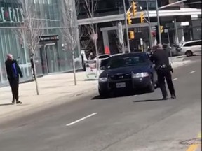 A police officer is caught on video facing off against and arresting the suspect in the van attacks on Toronto's Yonge Street on April 23, 2018.