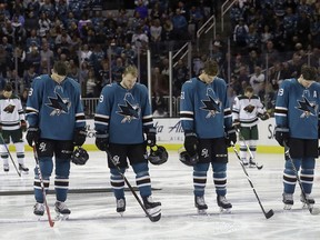 San Jose Sharks' Tomas Hertl, from the Czech Republic; Mikkel Boedker, from Denmark; Justin Braun; and Logan Couture, from left, observe a moment of silence with Minnesota Wild players, rear, for the victims of a bus crash involving a youth hockey team in Canada, before an NHL hockey game in San Jose, Calif., Saturday, April 7, 2018.