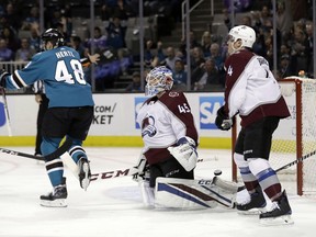 Colorado Avalanche goaltender Jonathan Bernier, center, reacts after giving up a goal to San Jose Sharks' Justin Braun, not seen, during the first period of an NHL hockey game Thursday, April 5, 2018, in San Jose, Calif.