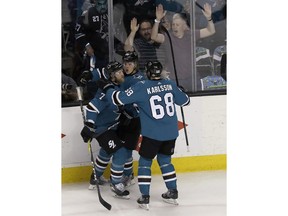 San Jose Sharks left wing Marcus Sorensen, center, is congratulated by defenseman Paul Martin (7) and right wing Melker Karlsson (68), from Sweden, after scoring a goal against the Anaheim Ducks during the first period of Game 4 of an NHL hockey first-round playoff series in San Jose, Calif., Wednesday, April 18, 2018.