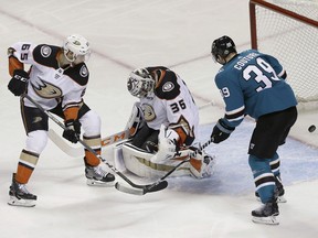 Anaheim Ducks defenseman Marcus Pettersson (65), from Sweden, and goalie John Gibson (36) and San Jose Sharks center Logan Couture (39) watch a goal scored by Sharks' Tomas Hertl during the third period of Game 4 of an NHL hockey first-round playoff series in San Jose, Calif., Wednesday, April 18, 2018. The Sharks won 2-1 to sweep the series.