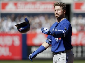 Toronto Blue Jays' Justin Smoak throws his helmet during the eighth inning of a baseball game against the New York Yankees at Yankee Stadium, Sunday, April 22, 2018, in New York. (AP Photo/Seth Wenig)