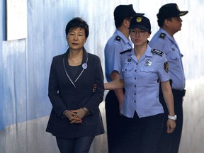In this Aug. 7, 2017, file photo, former South Korean President Park Geun-hye, left, arrives for her trial at the Seoul Central District Court in Seoul, Monday, Aug. 7, 2017.