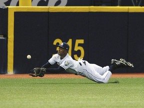 Tampa Bay Rays left fielder Mallex Smith robs Philadelphia Phillies' J.P. Crawford of a base hit during the fifth inning of a baseball game Saturday, April 14, 2018, in St. Petersburg, Fla.