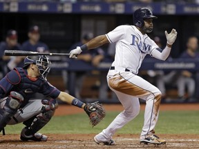 Tampa Bay Rays' Denard Span, right, lines a two-run double off Minnesota Twins starting pitcher Lance Lynn during the fifth inning of a baseball game Friday, April 20, 2018, in St. Petersburg, Fla. Catching for the Twins is Jason Castro.