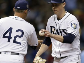 Tampa Bay Rays manager Kevin Cash left, takes pitcher Ryan Yarbrough out of the game against the Philadelphia Phillies during the fourth inning of a baseball game Sunday, April 15, 2018, in St. Petersburg, Fla.