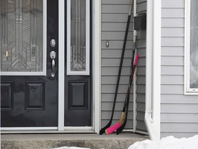 Hockey sticks sit on the front porch of a house in Humboldt, Sask., on Monday, April 9, 2018.