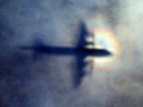In this March 31, 2014 file photo, the shadow of a Royal New Zealand Air Force P3 Orion is seen on low level cloud while the aircraft searches for missing Malaysia Airlines Flight MH370 in the southern Indian Ocean, near the coast of Western Australia.