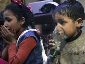 This image released early Sunday, April 8, 2018 by the Syrian Civil Defence White Helmets, shows a child receiving oxygen through respirators following an alleged poison gas attack in the rebel-held town of Douma, near Damascus, Syria.