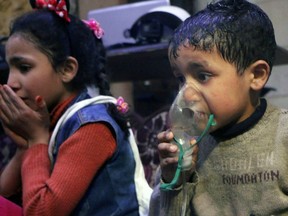 FILE - This file  image released early Sunday, April 8, 2018 by the Syrian Civil Defense White Helmets, shows a child receiving oxygen through a respirator following an alleged poison gas attack in the rebel-held town of Douma, near Damascus, Syria. The Organization for the Prohibition of Chemical Weapons has been thrust once again into the international limelight by a nerve agent attack on a former Russian spy in Britain and allegations of a chemical bombardment on the Syrian city of Douma. It is now attempting to investigate, but its experts have not yet been able to visit the scene. (Syrian Civil Defense White Helmets via AP, File)