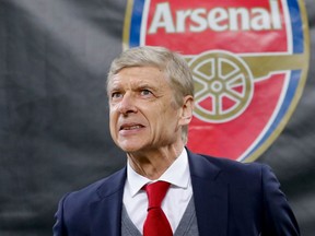 FILE - In this Thursday, March 8, 2018 file photo Arsenal's manager Arsene Wenger waits for the kick-off of the Europa League, round of 16 first-leg soccer match between AC Milan and Arsenal, at the Milan San Siro stadium, Italy. Arsenal manager Arsene Wenger says he will leave the English club at the end of the season after more than 21 years in charge.