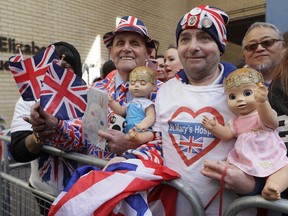 Royal fans John Loughrey, right, and Terry Hutt pose for a photo opposite the Lindo wing at St Mary's Hospital in London London, Monday, April 23, 2018. Kensington Palace says Prince William's wife, the Duchess of Cambridge has entered a London hospital to give birth to the couple's third child.