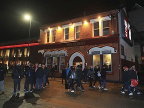 People walk past the Albert pub on Walton Breck Road, Liverpool, England after the Champions League, semifinal first leg soccer match at Anfield, Tuesday April 24, 2018. Police say a man was attacked outside the Albert pub near Anfield before the Champions League game between Liverpool and Roma on Tuesday.