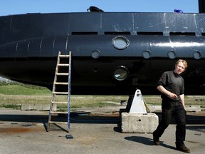 FILE - This April 30, 2008 file photo shows a submarine and its owner Peter Madsen. One of the most talked-about and macabre court cases in recent Danish history is set to conclude Wednesday, April 25, 2018 when the verdict is handed down on whether Peter Madsen tortured and murdered a Swedish journalist during a private submarine trip.