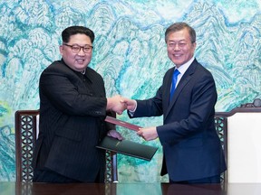 In this April 27, 2018 file photo, North Korean leader Kim Jong Un, left, and South Korean President Moon Jae-in shake hands after signing on a joint statement at the border village of Panmunjom in the Demilitarized Zone, South Korea.