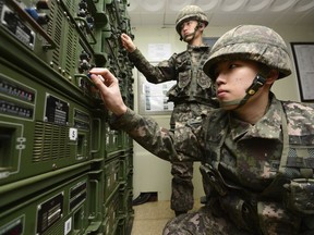 FILE - In this Jan. 8, 2016 file photo, South Korean army soldiers adjust equipment used for propaganda broadcasts near the border area between South Korea and North Korea in Yeoncheon, South Korea. South Korea says it has halted anti-Pyongyang propaganda broadcasts on the border ahead of the April 27, 2018, inter-Korean talks. The South's Defense Ministry says it turned off loudspeaker broadcasts Monday, April 23, to try to ease military tensions and establish an environment for peaceful talks. South Korea had broadcast anti-North propaganda across the border since the North's fourth nuclear test in early 2016.