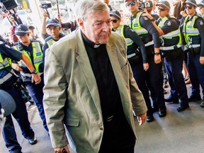 FILE - In this March 5, 2018, file photo, Cardinal George Pell arrives for a hearing at an Australian court in Melbourne, Australia. A lawyer for the most senior Vatican official ever charged in the Catholic Church sex abuse crisis told the Australian court on Tuesday, April 17, 2018 that Pell could have been targeted with false accusations to punish him for the crimes of other clerics.