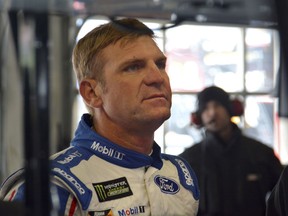 Clint Bowyer looks up at a computer display after participating in a practice session for the NASCAR Cup series auto race in Fort Worth, Texas, Saturday, April 7, 2018.