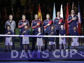 The United States team stands for the national anthem before a Davis Cup quarterfinal singles tennis match against Belgium Friday, April 6, 2018, in Nashville, Tenn.