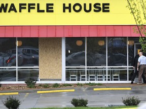 A window is boarded up at the Waffle House which remains closed Monday, April 23, 2018, after several people were shot and killed by a gunman early Sunday morning in Nashville, Tenn. The suspect is still at large.