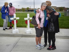 Members of the Billy Graham Rescue Response Team pray with Lancelot DeSilva, far left, Susan Cox and Valerie Aaron, right, at the memorial for the four people that were killed Sunday at the Waffle House in Antioch, Tenn., Wednesday, April 25, 2018.
