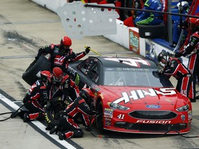 The crew of Kurt Busch works on his car during a NASCAR Cup Series auto race, Sunday, April 15, 2018, in Bristol, Tenn.